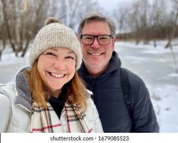 Smiling Middle Age Couple Outdoors In Winter Taking A Selfie