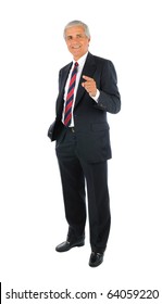 Smiling middle aged businessman standing and pointing with one hand and the other hand in his pocket. Business man is in full  length over a white background.