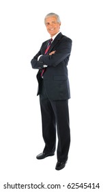 Smiling middle aged businessman in a suit and tie standing with his arms folded. Full length over a white background.