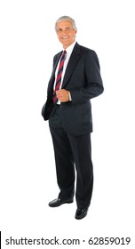 Smiling middle aged businessman in a suit and tie standing with one hand in his pocket. Business man is in full  length over a white background.