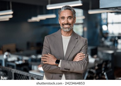 Smiling middle aged ceo business man looking at camera, portrait. Confident happy mature older professional businessman executive manager, successful lawyer in suit standing arms crossed in office.