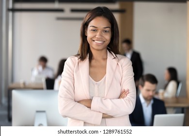 Smiling Millennial African American Corporate Employee Executive, Mixed Race Office Worker Or Team Leader Looking At Camera, Female Young Black Professional Business Coach Company Manager Portrait