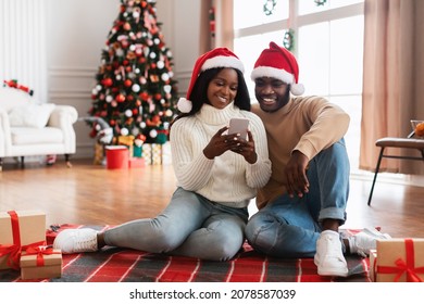 3 Excited Black Lady Sitting With Christmas Presents And Smartphone ...