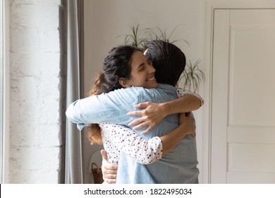 Smiling Millennial Caucasian Couple Embrace Show Love And Care, Feel Grateful Thankful In Family Relationship. Happy Young Man And Woman Hug Reconcile Make Peace After Fight. Marriage Therapy Concept.