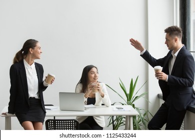 Smiling Millennial Diverse People Chatting During Coffee Break Together, Friendly Multi-ethnic Colleagues Talking Listening To Coworker Telling Story In Office Room, Good Team Relations Concept