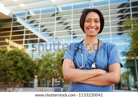 Smiling mixed race female healthcare worker outside hospital
