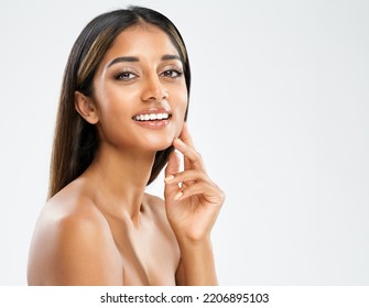 Smiling Model with perfect White Teeth. Beautiful Indian Girl Cheerful Smiling. Beauty Woman with Smooth Skin and Natural Lip Make up over White Background. Female Skincare and Cosmetology