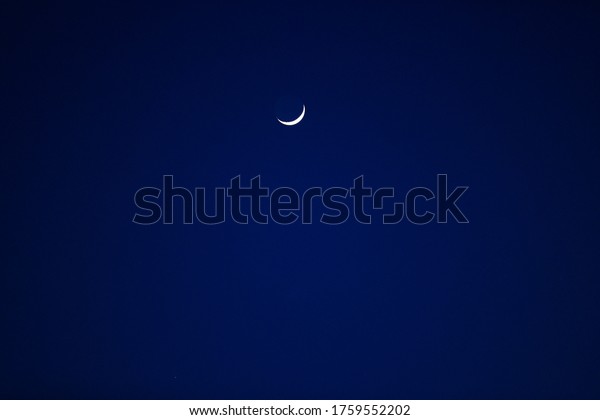Smiling moon over the dark\
blue sky