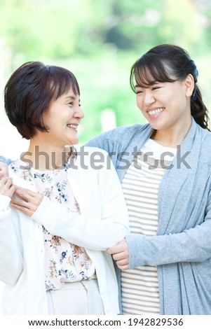 A smiling mother and daughter staring at each other