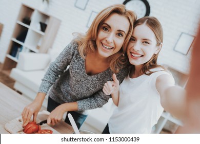 Smiling Mother and Daughter Taking Selfie in Kitchen. Relationship in Family. Holiday at Home. Healthy Food and Lifestyle Concept. Cooking Together. Happiness in Family Concept. Taking Photo. - Powered by Shutterstock