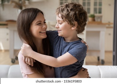 Smiling Mother Looking At Little Son Close Up, Happy Mum And Cute Preschool Boy Hugging, Having Fun At Home, Sitting On Couch, Family Enjoying Tender Moment, Expressing Love And Support