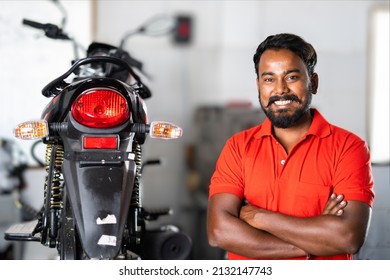 Smiling Motorbike Mechanic Standing With Crossed Arms By Looking At Camera - Concept Of Repair Or Maintenance Service And Blue Collar Jobs