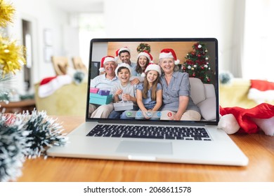 Smiling Multi Generation Caucasian Family In Santa Hats On Laptop Christmas Video Call Screen. Christmas, Festivity And Communication Technology.