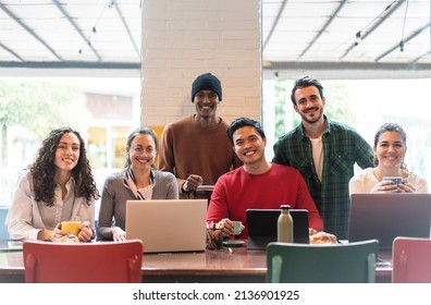 Smiling Multiethnic Coworkers Looking At Camera Making Team Picture In Modern Office Together - Happy Diverse Work Group Or Department Laugh Posing For Photo At Workplace - Show Unity And Cooperation