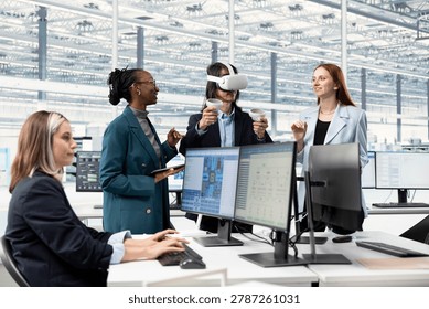 Smiling multiethnic engineering team using VR gear in microchip factory RD office to look at circuit layouts, happy diverse coworkers using virtual reality to create PCB designs in research center. - Powered by Shutterstock - Get 15% off with code: PIKWIZARD15