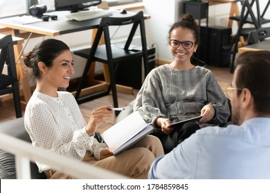 Smiling Multiethnic Young Colleagues Have Fun Take Part In Educational Motivational Training In Office, Happy Diverse Multiracial Employees Engaged In Teambuilding Activity At Meeting Or Briefing