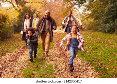 Smiling Multi-Generation Family Having Fun With Children Walking Through Autumn Countryside Together - Powered by Shutterstock