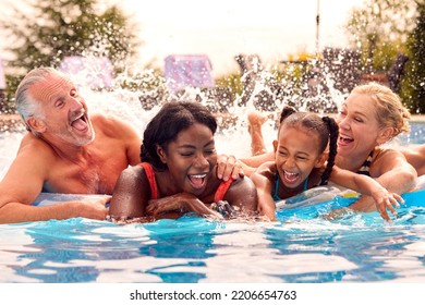 Smiling Multi-Generation Family On Summer Holiday Relaxing In Swimming Pool On Airbed - Powered by Shutterstock