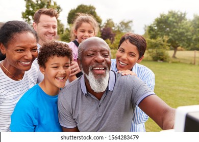 Smiling Multi-Generation Mixed Race Family Having Fun In Garden 