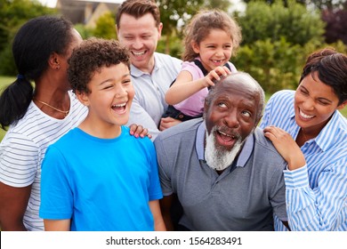 Smiling Multi-Generation Mixed Race Family Having Fun In Garden At Home