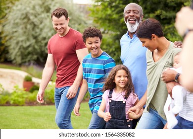 Smiling Multi-Generation Mixed Race Family In Garden At Home Together