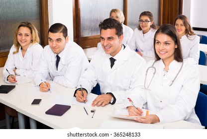 Smiling Multinational Interns And Professor Having Discussion At Medical Faculty