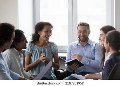 Smiling multiracial colleagues have fun take part in educational motivational training at workplace. Happy diverse office employees engaged in team building event. Business meeting, briefing concept - Shutterstock ID 2187281959