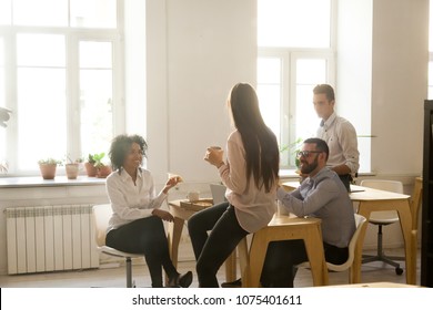 Smiling Multiracial Colleagues Talking Eating Pizza At Lunch In Office Room, Diverse Team People Enjoy Meal At Coffee Break Chatting Together, Food Delivery Or Good Friendly Relations At Work Concept