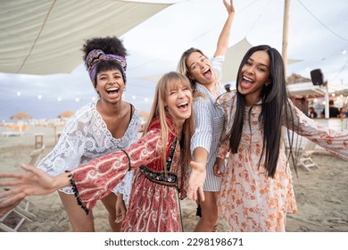 Smiling multiracial girls dancing at sunset beach party - four young girls having fun at  bar  - Powered by Shutterstock