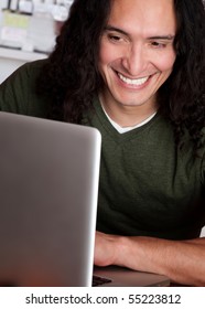 Smiling Native American Male Working On A Laptop