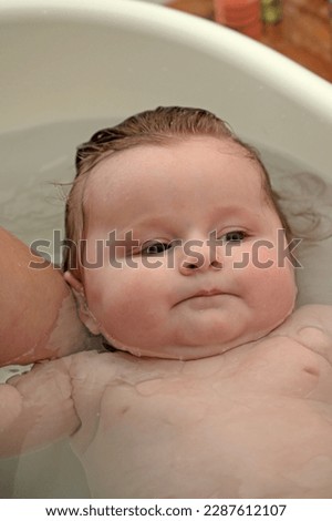 Similar – Newborn in the bathtub