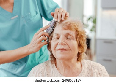 Smiling nurse brushes a senior woman's hair, showing care and compassion in a heartwarming moment of trust and support - Powered by Shutterstock