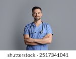 Smiling nurse with stethoscope on grey background