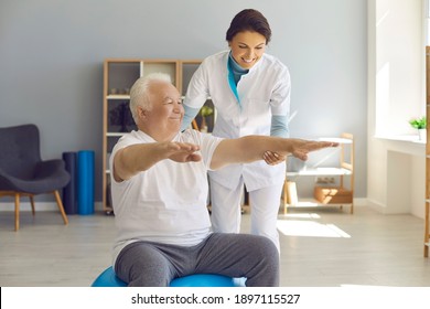 Smiling Nurse Supporting Happy Positive Chubby Mature Man Doing Medical Exercise On Swiss Ball. Physical Activity, Senior Health, Assisted Living, Chiropractic Fitness Therapy, Osteoporosis Prevention