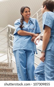 Smiling Nurse Talking With A Colleague In Hospital Ward, Healthcare Workers In The Coronavirus Covid19 Pandemic