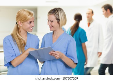 Smiling Nurses Holding A Clipboard At Hospital, Healthcare Workers In The Coronavirus Covid19 Pandemic