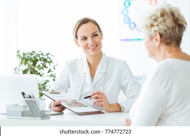 Smiling Nutritionist Showing A Healthy Diet Plan To Female Patient With Diabetes