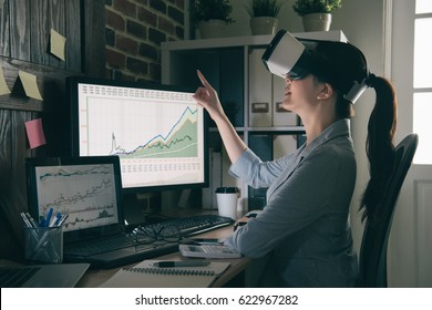 smiling office woman getting experience using VR headset glasses at company with gesticulating. asian girl pointing touch air by virtual reality. - Powered by Shutterstock