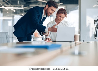 Smiling office worker shows creative project mature female businesswoman on laptop. Business concept - Shutterstock ID 2152101611