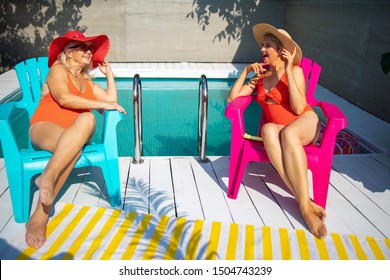 Smiling Old Lady Talking With Friend Near The Swimming Pool Stock Photo