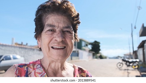 Smiling Old Latin Woman. Beautiful Senior Woman Looking At The Camera With A Warm Friendly Smile And Attentive Expression. Elderly Woman Laughing.