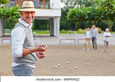 Smiling Old Man With Ball For Boule Game In A City