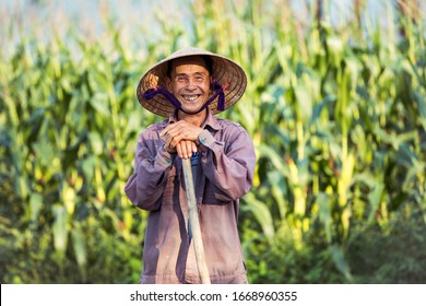 Smiling old Vietnamese farmer with conical hat (non la)