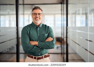 Smiling older bank manager or investor, happy middle aged business man boss leader, confident mid adult professional businessman executive standing in office hallway, mature entrepreneur portrait. - Powered by Shutterstock