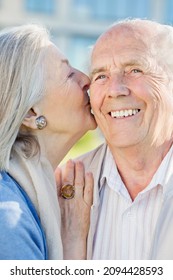 Smiling Older Couple Kissing Outdoors