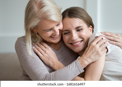 Smiling Older Mother And Adult Daughter Hugging And Laughing, Family Having Fun Together, Young Woman And Mature Mum Enjoying Tender Moment, Expressing Love And Support, Two Generations Close Up