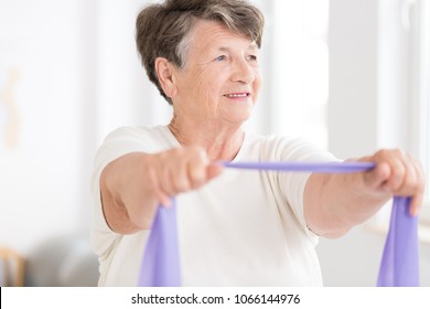 Smiling Older Woman Exercising Purple Elastic Stock Photo 1066144976 ...