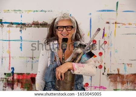 Image, Stock Photo Elderly woman artist holding a paintbrush in a studio