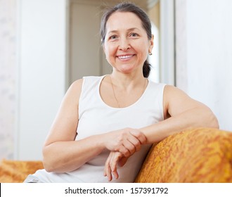Smiling ordinary mature woman in home interior - Shutterstock ID 157391792