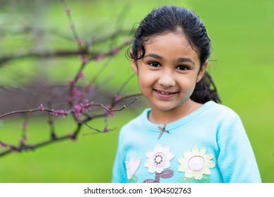 Smiling Outdoor Portrait of a Little Girl in Spring